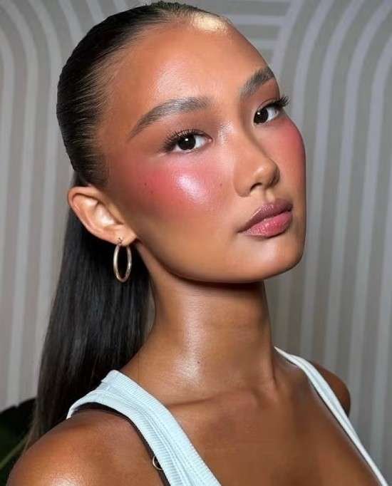 Maquiagem com blush vermelho.